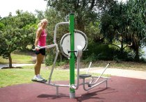 Person tränar dips och överkroppsstyrka på Tibas utegym i grön färg i park